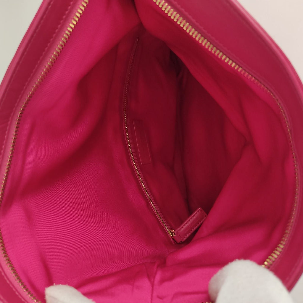 SAINT LAURENT maxi clutch bag in fuchsia leather
