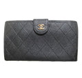 CHANEL Vintage black caviar leather wallet with stitches and gold tone CC motif